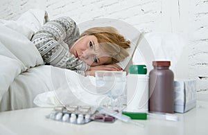 Sick woman feeling bad ill lying on bed suffering headache winter cold and flu virus having medicines