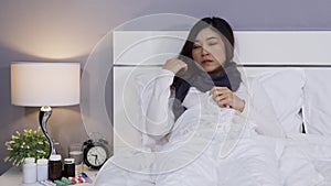 Sick woman feeling cold and sneezing in bed