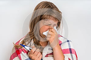 Sick woman with flu or cold sneezing into handkerchief