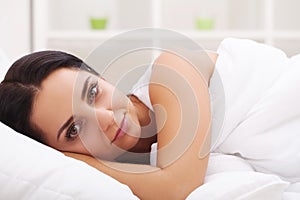 Sick Woman. Flu. Girl with cold lying under a blanket holding a