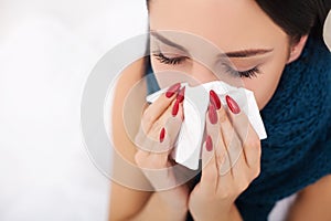 Sick Woman. Flu. Woman Caught Cold. Sneezing into Tissue