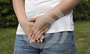 Sick woman with hands holding pressing her crotch lower abdomen. Medical or gynecological problems, healthcare concept