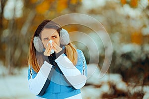 Sick Woman Having a Cold in Wintry Weather Outdoors