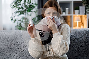 Sick woman holding nasal spray