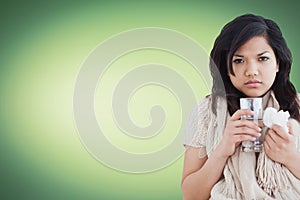 Sick woman holding a tissue and a glass of water