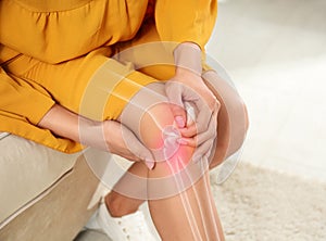 Sick woman at home, closeup. Digital compositing with illustration of knee joint photo