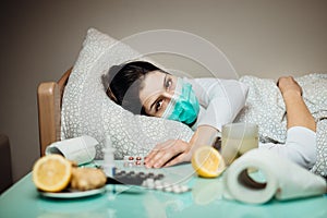 Sick woman in home quarantine bed self-isolation.Severe pneumonia disease.Flu infected patient with mask suffering from symptoms