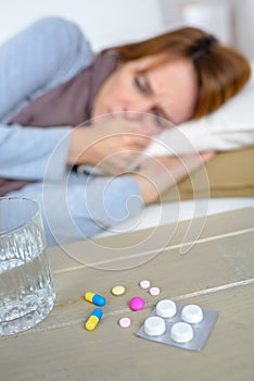 Sick woman laying on sofa