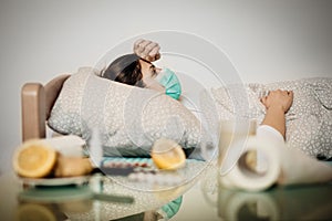 Sick woman with mask in quarantine bed self isolation.Coronavirus Covid-19 patient having pneumonia disease symptoms.Prevention