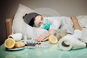 Sick woman with mask in quarantine bed self isolation.Coronavirus Covid-19 patient having pneumonia disease symptoms.Prevention photo