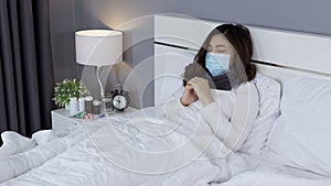 Sick woman in medical mask feeling cold and coughing and suffering from virus disease and fever in bed, coronavirus covid-19 pan