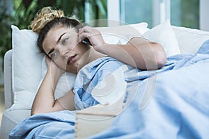 Sick woman with phone