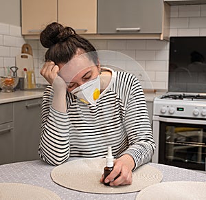 Sick woman in protective mask suffering from headache