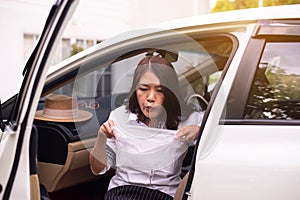 Sick woman puke or vomiting into plastic bag in car,Car Sick and motion sickness photo