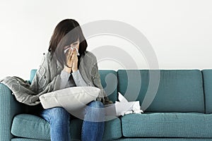 Sick woman sitting on the couch