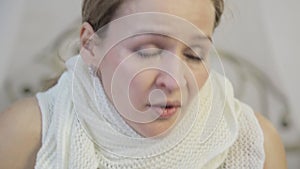 Sick woman sneezes loudly and wipes his nose