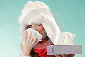 Sick woman sneezing in tissue. Winter cold.