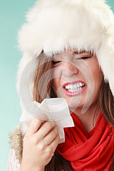 Sick woman sneezing in tissue. Winter cold.