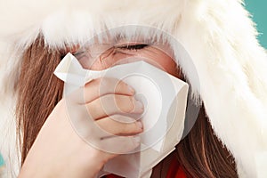 Sick woman sneezing in tissue. Winter cold.