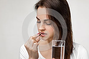 Sick woman taking pill painkiller medicine