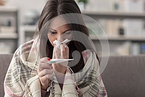 Sick woman taking temperature