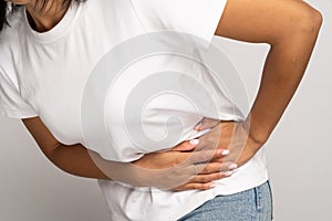 Sick woman touching left side suffer from acute abdominal pain in stomach, appendix or pancreatitis