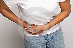 Sick woman touching right side suffer from acute abdominal pain in stomach, appendix or pancreatitis