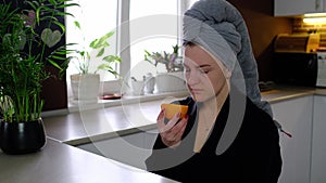 Sick woman trying to sense smell of fresh orange