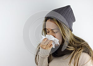 Sick woman wearing a beanie.