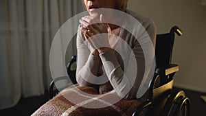 Sick woman wheelchair feeling lonely and depressed, hopelessness in nursing home