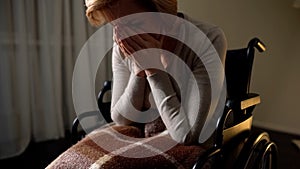 Sick woman wheelchair feeling lonely and depressed, hopelessness in nursing home