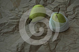 Sick wounded pear wrapped with bandage on brown background