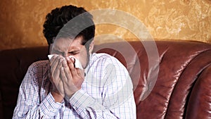 Sick young man got flu allergy sneezing in handkerchief blowing nose