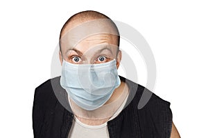 Sick young man with a surprised look in a medical mask. Virus protection during an influenza epidemic. corona virus