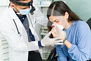 Sick young woman bleeding from the nose