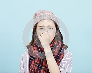 Sick young woman blowing her nose