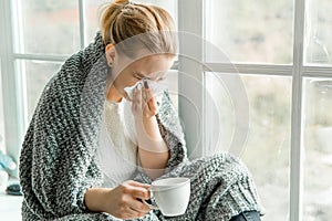 Sick young woman with cold and flu at home