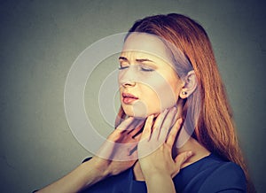 Sick young woman having pain in her throat