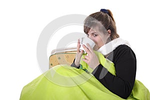 Sick young woman sitting under a bedspread photo