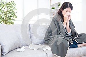 Sick young woman sneeze at home