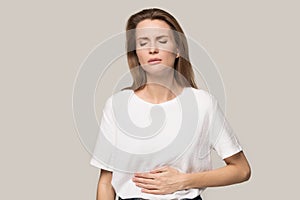 Sick young woman touch stomach suffer from indigestion