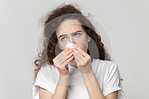 Sick young woman use tissue blowing runny nose photo