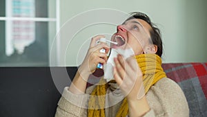 Sick Young Woman Using Throat Spray