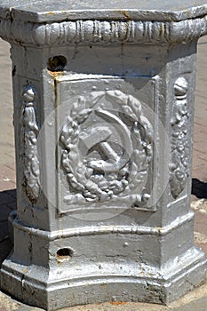 Sickle and hammer on the base of the lighting pole. Sovetsk, Kaliningrad region