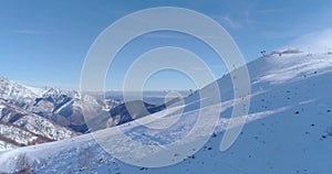 Side aerial follow people skier alpine skiing in winter snowy mountain ski track field in sunny day.Italy Alps mountains