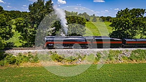 Side Aerial View of a Steam Streamlined Locomotive Blowing Smoke