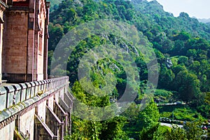 Side of Basilica of Covadonga in a hill, with the green forest at the background, in Cangas de Onis, Asturias, Spain