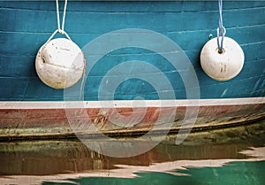 Side of Boat with Buoys photo