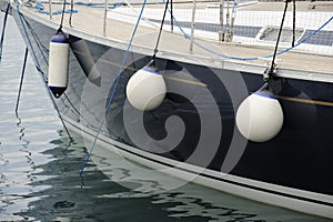 Side of a boat with docking fenders