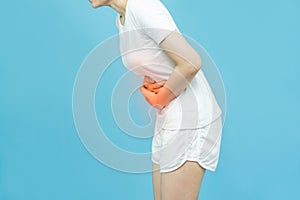 The side body of a woman in white clothes put her hands on the Stomach area at spot of ache and mark red, abdominal pain, Health-